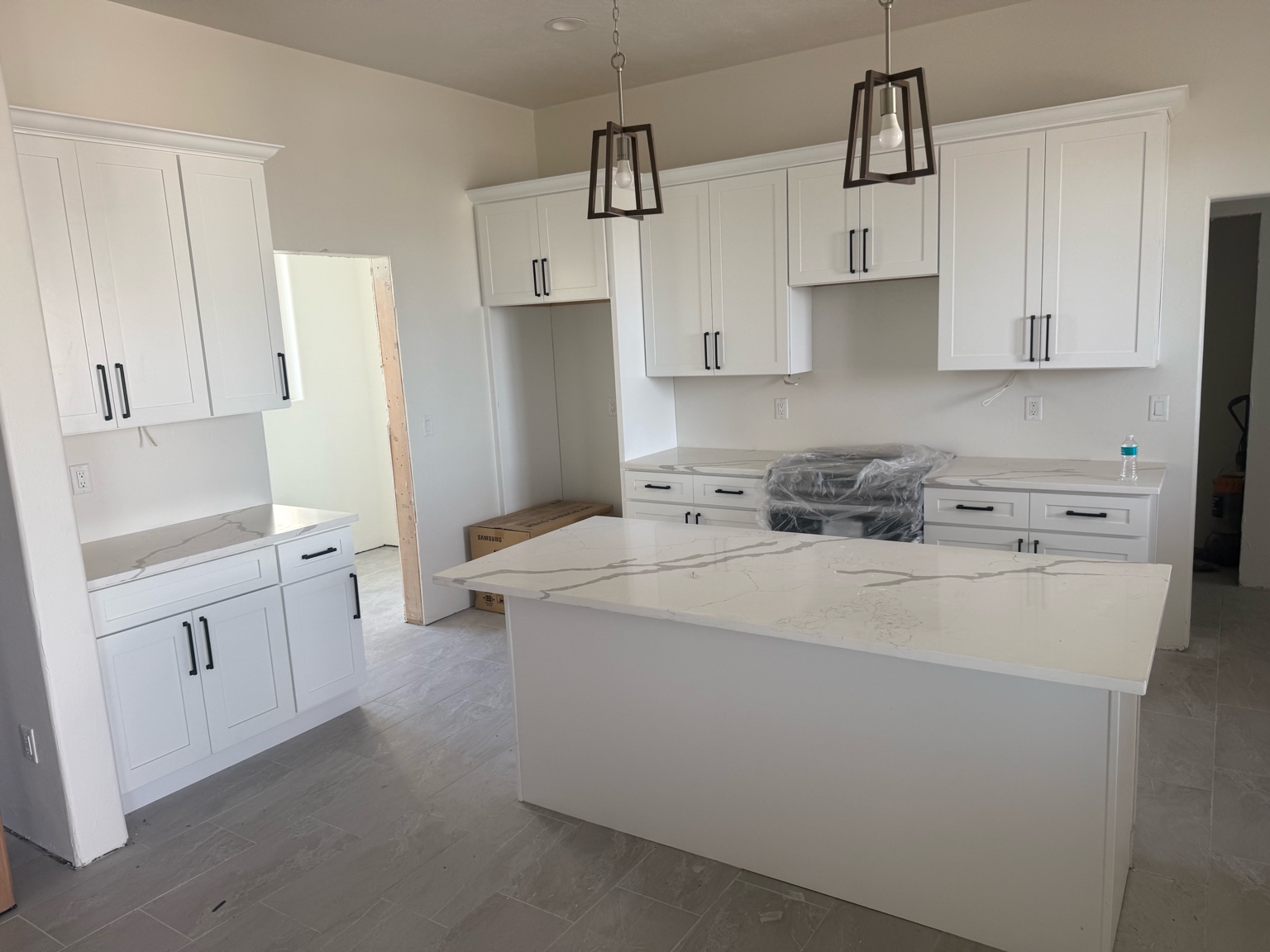 Custom bar area with black countertop and floating shelves